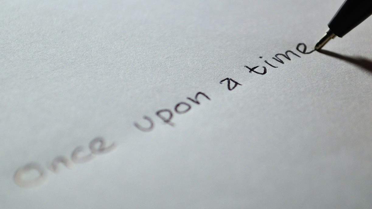 Written words 'once upon a time' written on paper