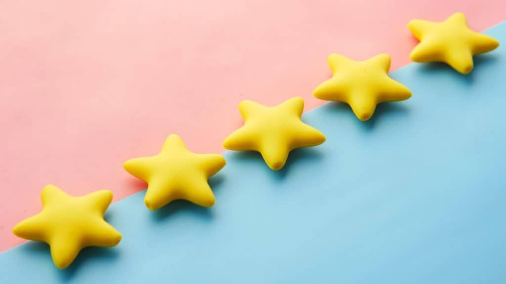 Five yellow stars on a blue and pink background