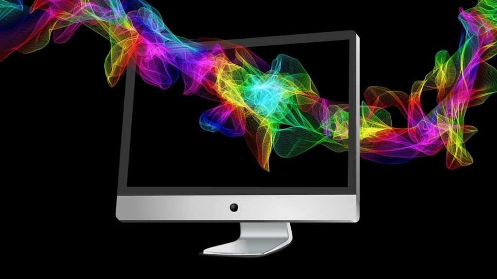 Colourful patterns flying through a black computer screen