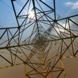 View from ground looking up into centre of electricity pylon