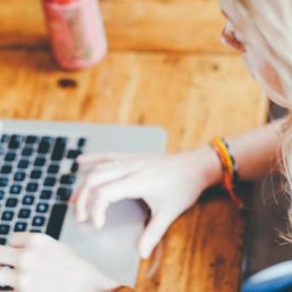 Blonde woman typing on laptop