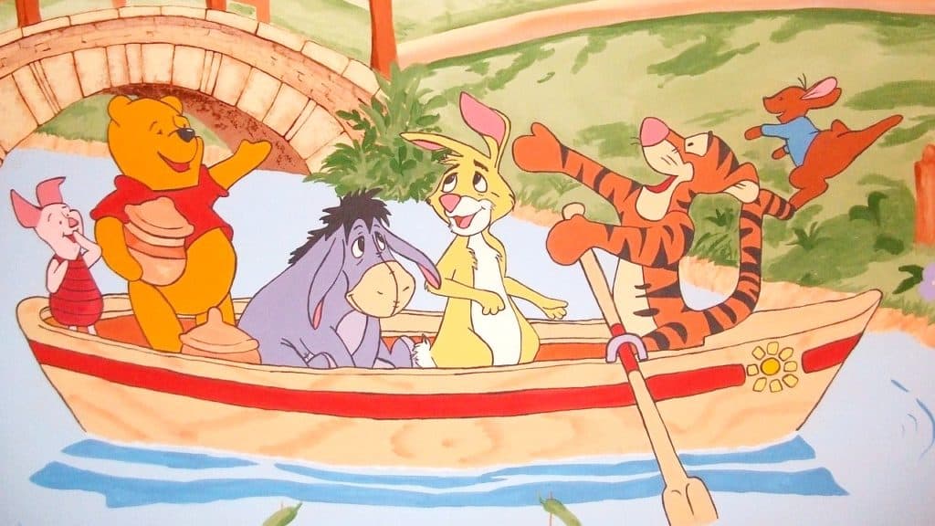 Winnie the Pooh and friends in a boat on a river