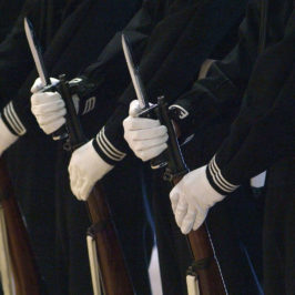 Close-up of miltary uniforms with white gloves in parade lineup